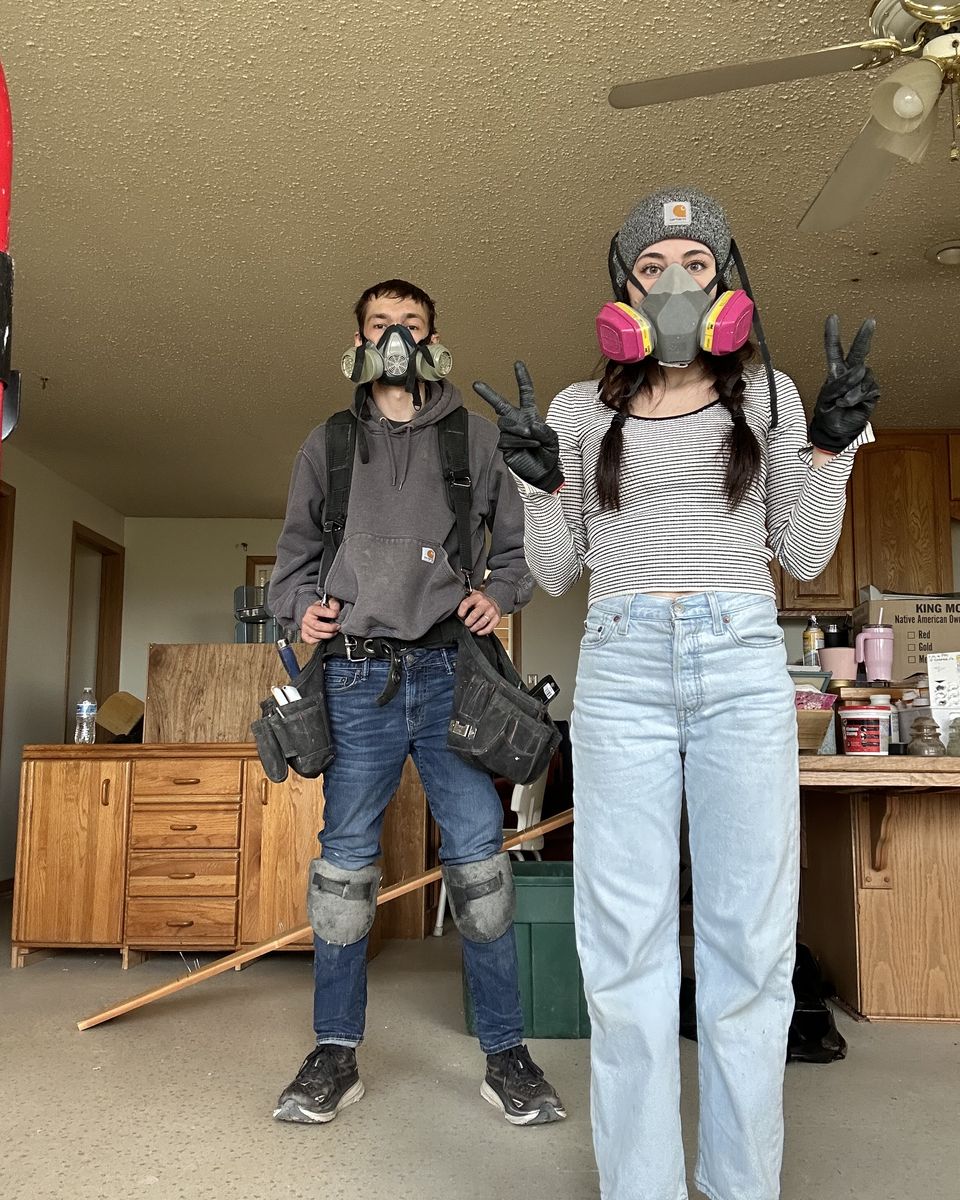 Jackson and Kaylie in respirators and work gear during a demo