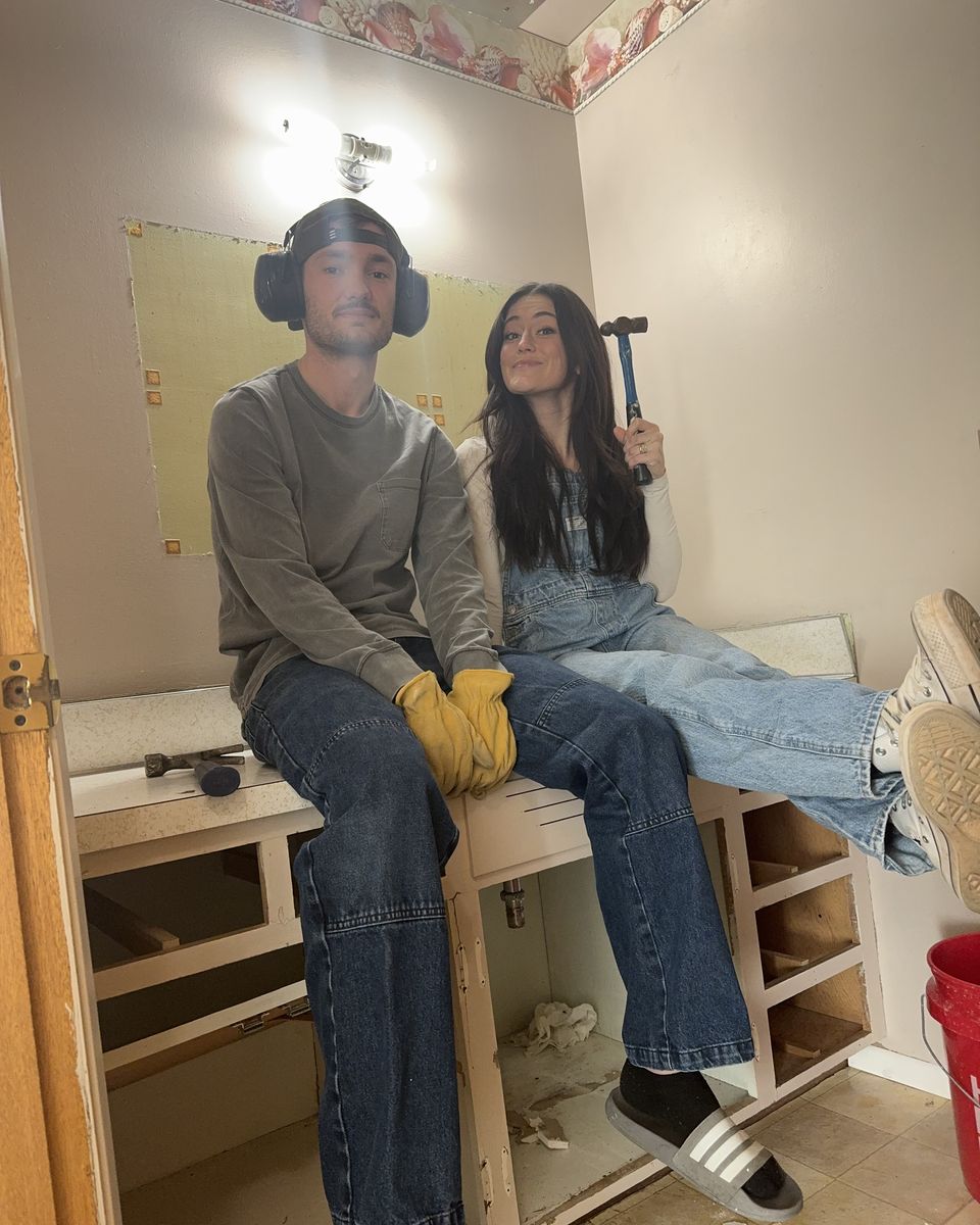 Jackson and Kaylie taking out an old bathroom vanity